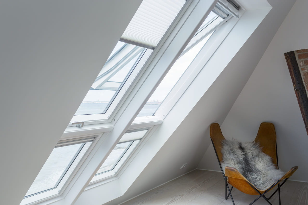 Two VELUX roof windows with slopping extensions and translucent pleated blinds installed