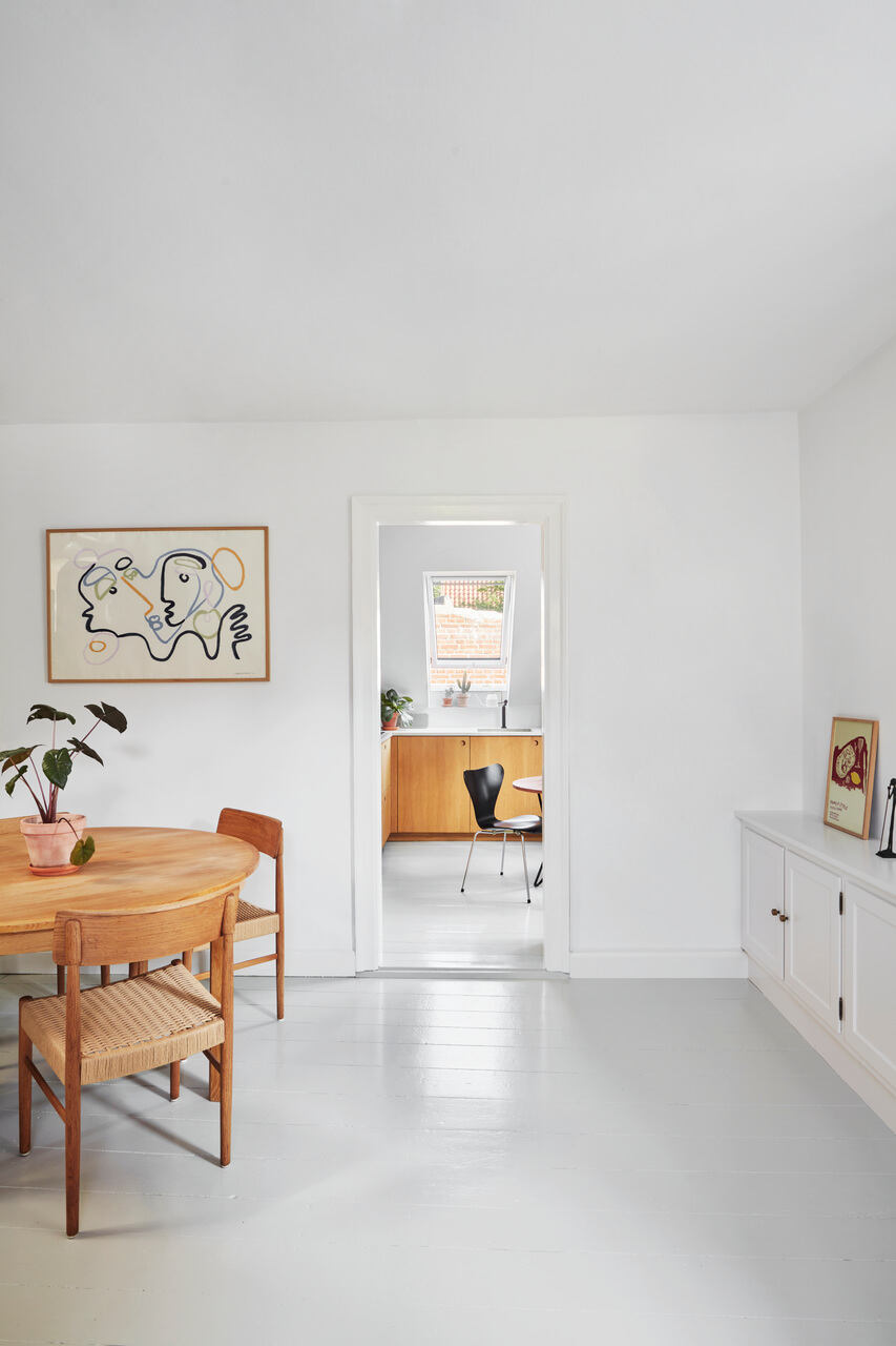White painted dining room with wooden furniture.