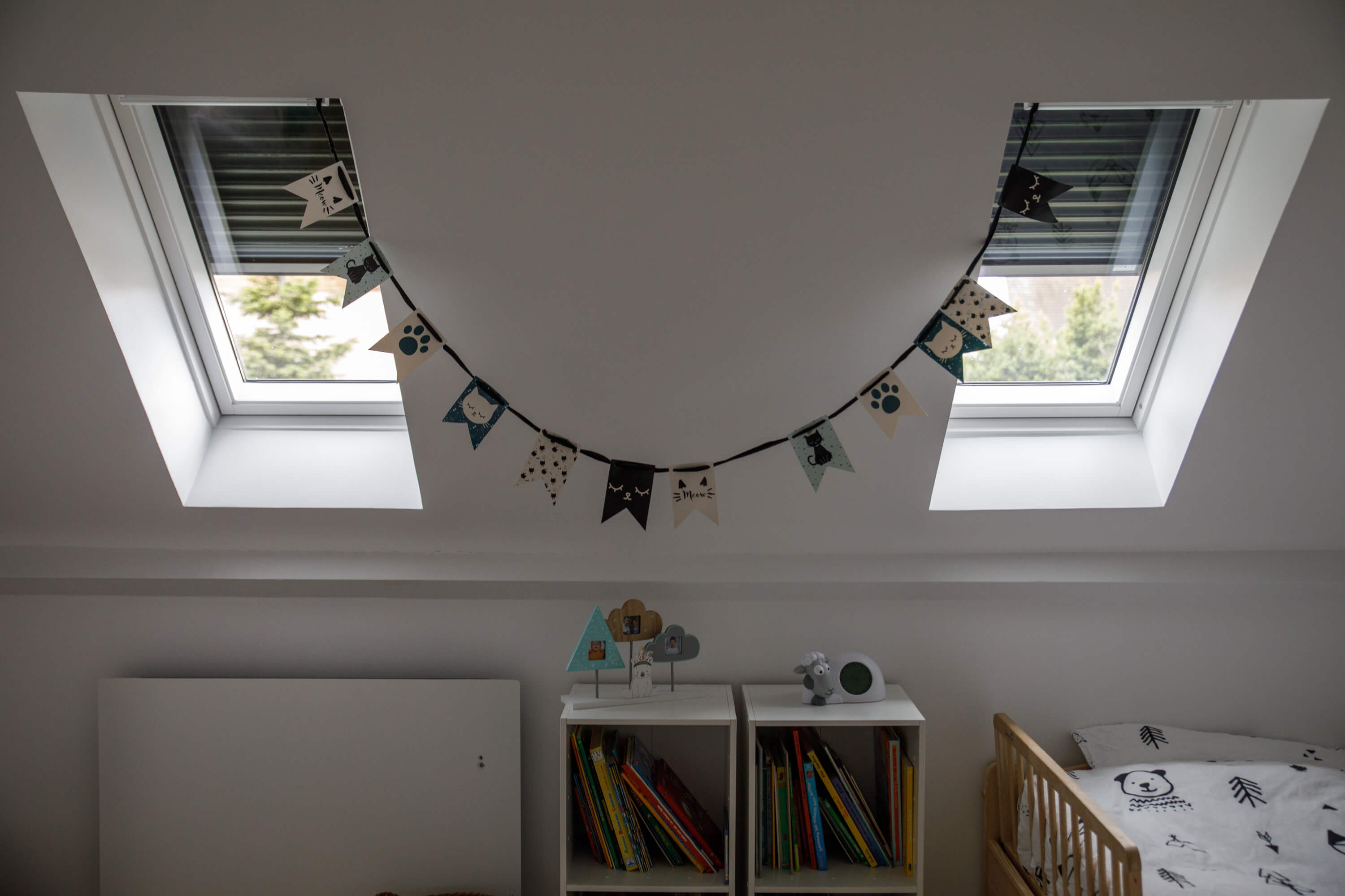 A room with two roof windows and shutters