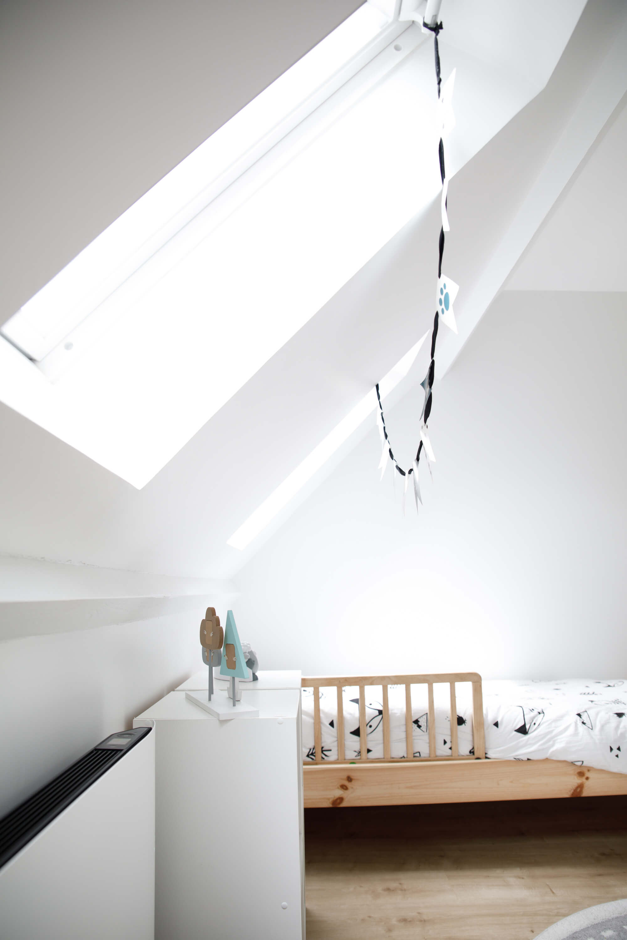 A side view of kids room with a wooden bed