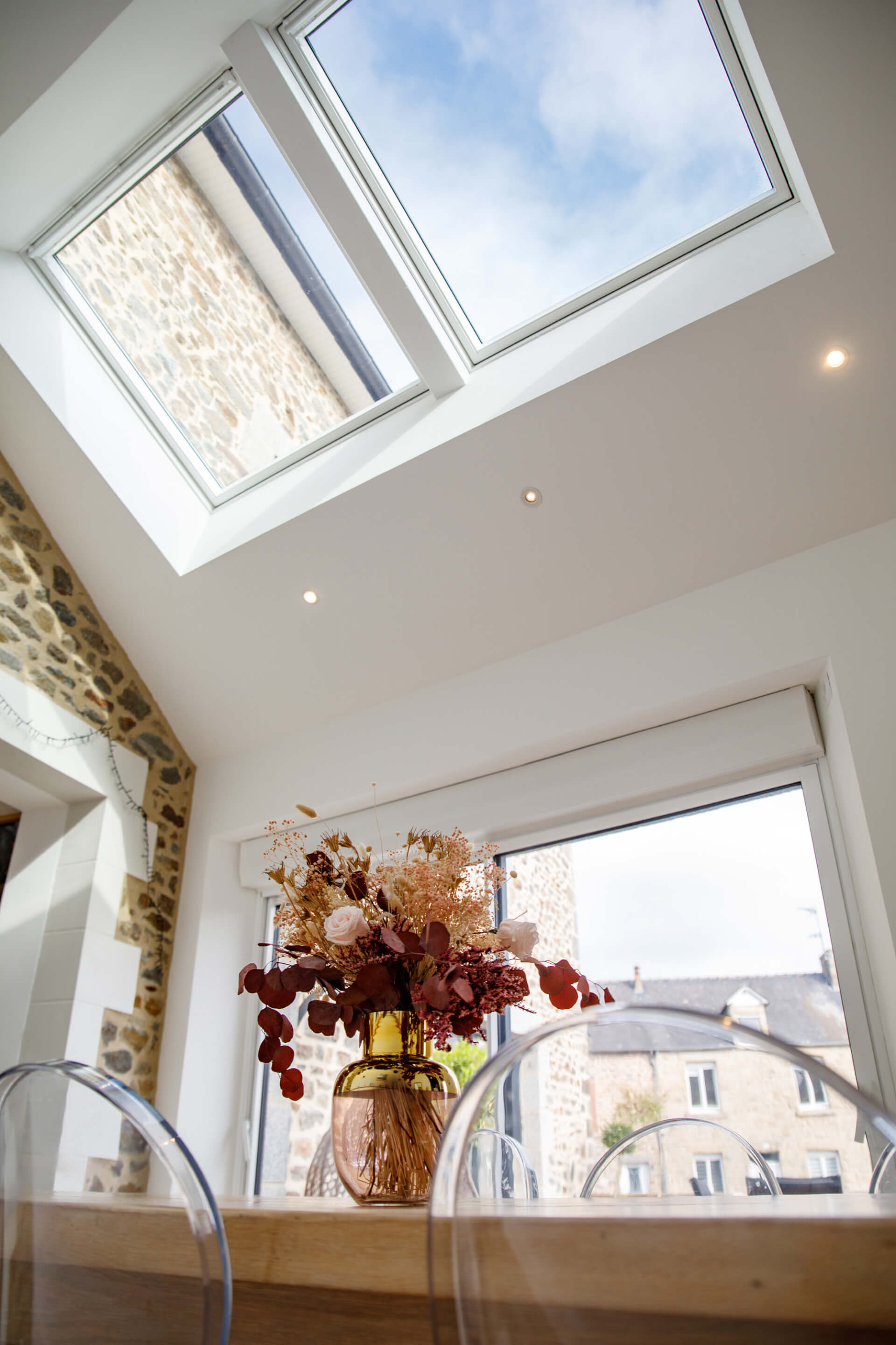 A view to a dining table and roof windows