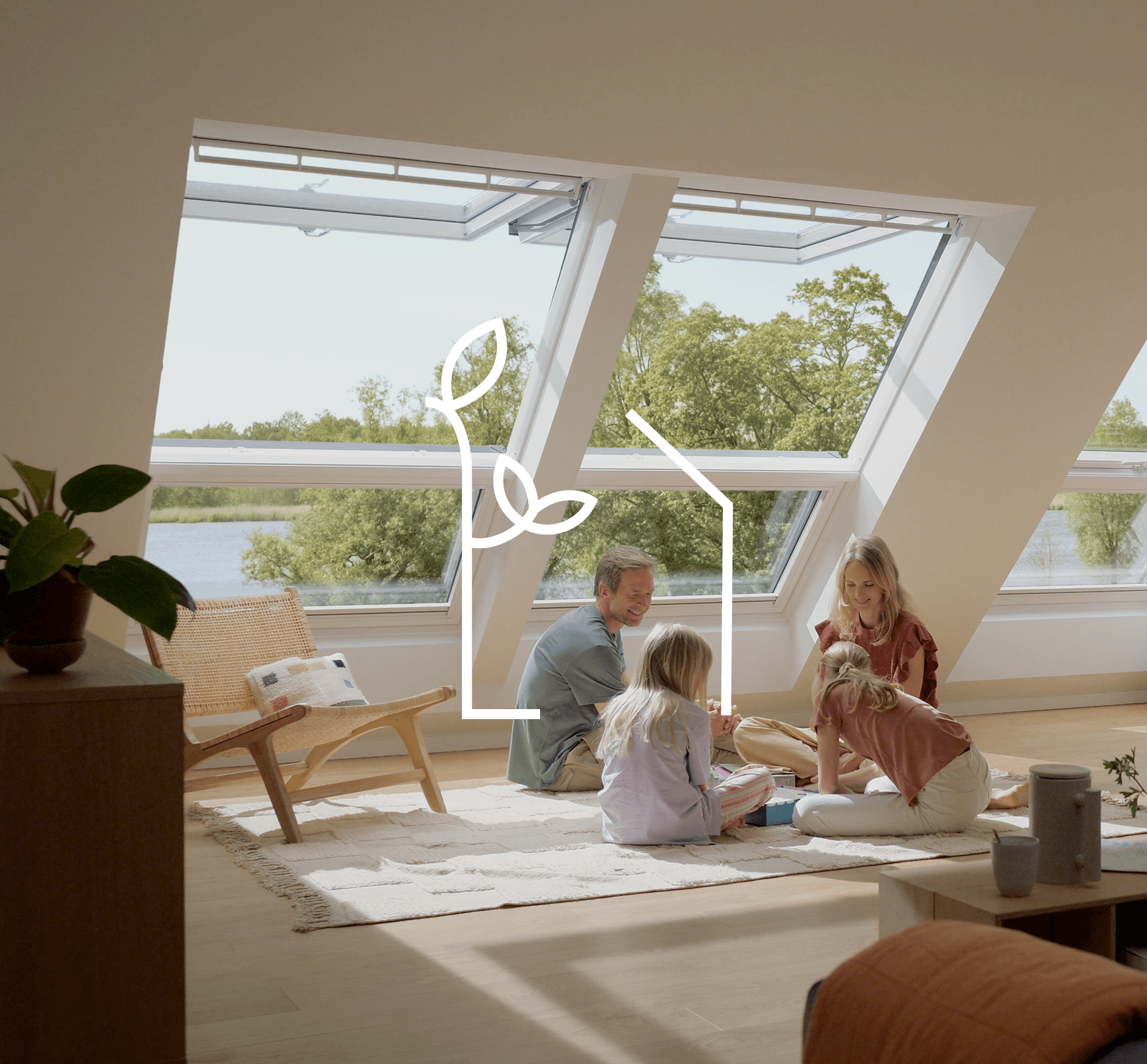 Four people sitting on the floor next to the roof windows.